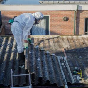 lead removal workforce in johns creek, ga wearing protective gear while removing asbestos cement from roof